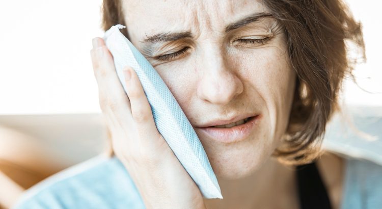 Girl, ice pack, toothache — "Aptamil 1: The Perfect Start to Your Baby’s Formula Journey"