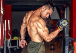 A fit, shirtless man showcasing biceps while lifting a dumbbell in a gym setting. — Natural Care and Balance with Ayurvedic M